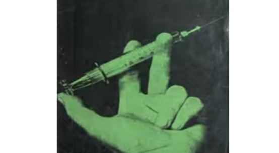 Green hand with a syringe and a black background. from: PWCD - vaccines.